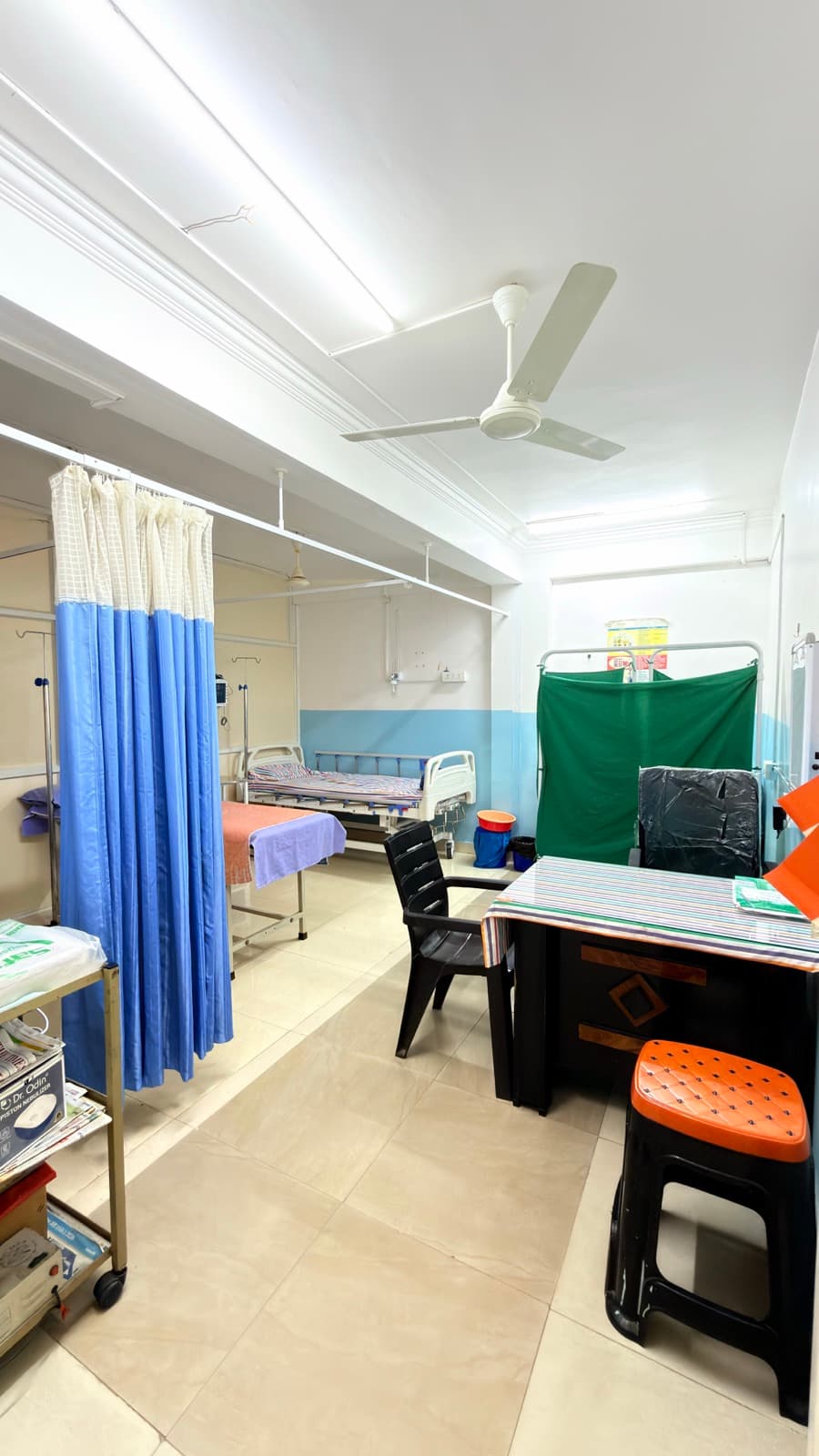 The general ward, with beds screened individually.