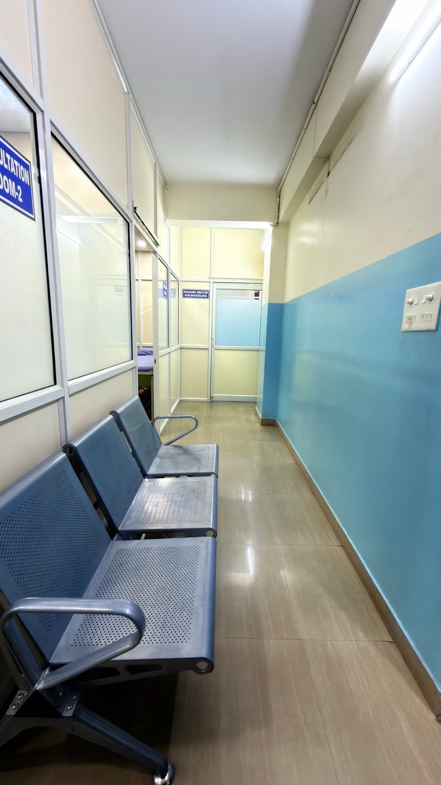 The consulting corridor, with seating outside each room.