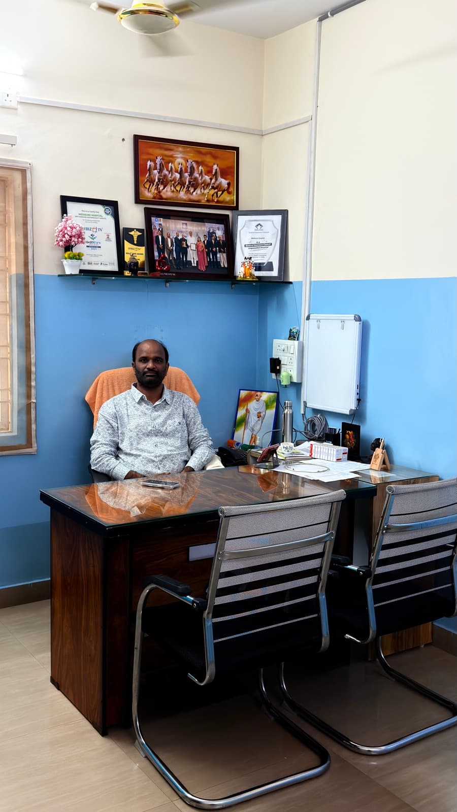 The managing director's office, and the hospital's awards behind the desk.