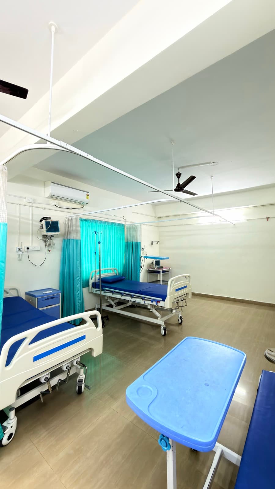 Beds made up and waiting in the same ward.